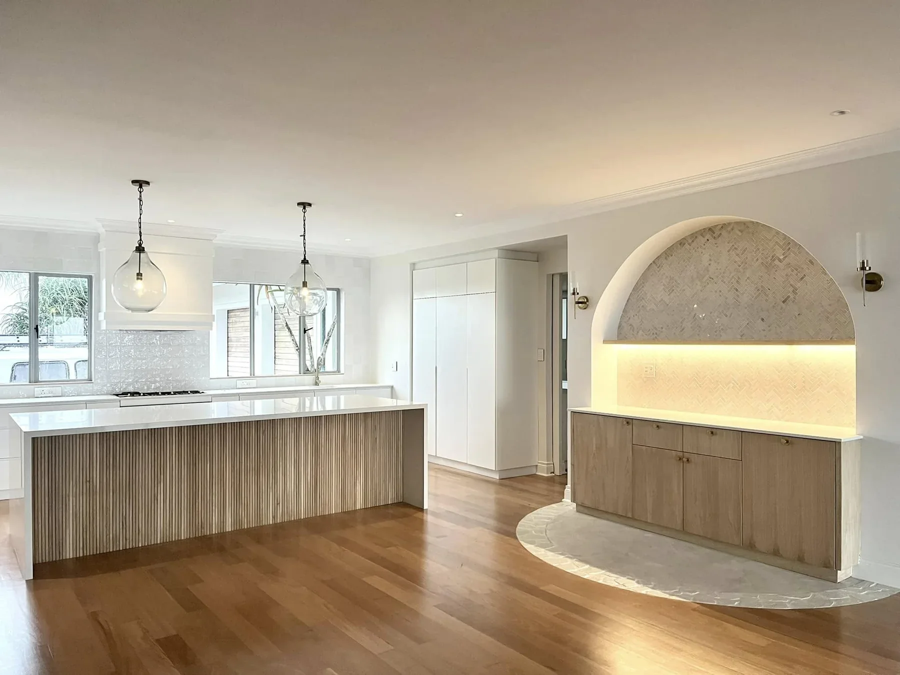 Country Kitchens residential kitchen with an integrated island and warm timber flooring